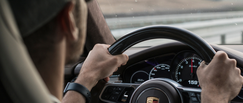 Person Driving A Porsche